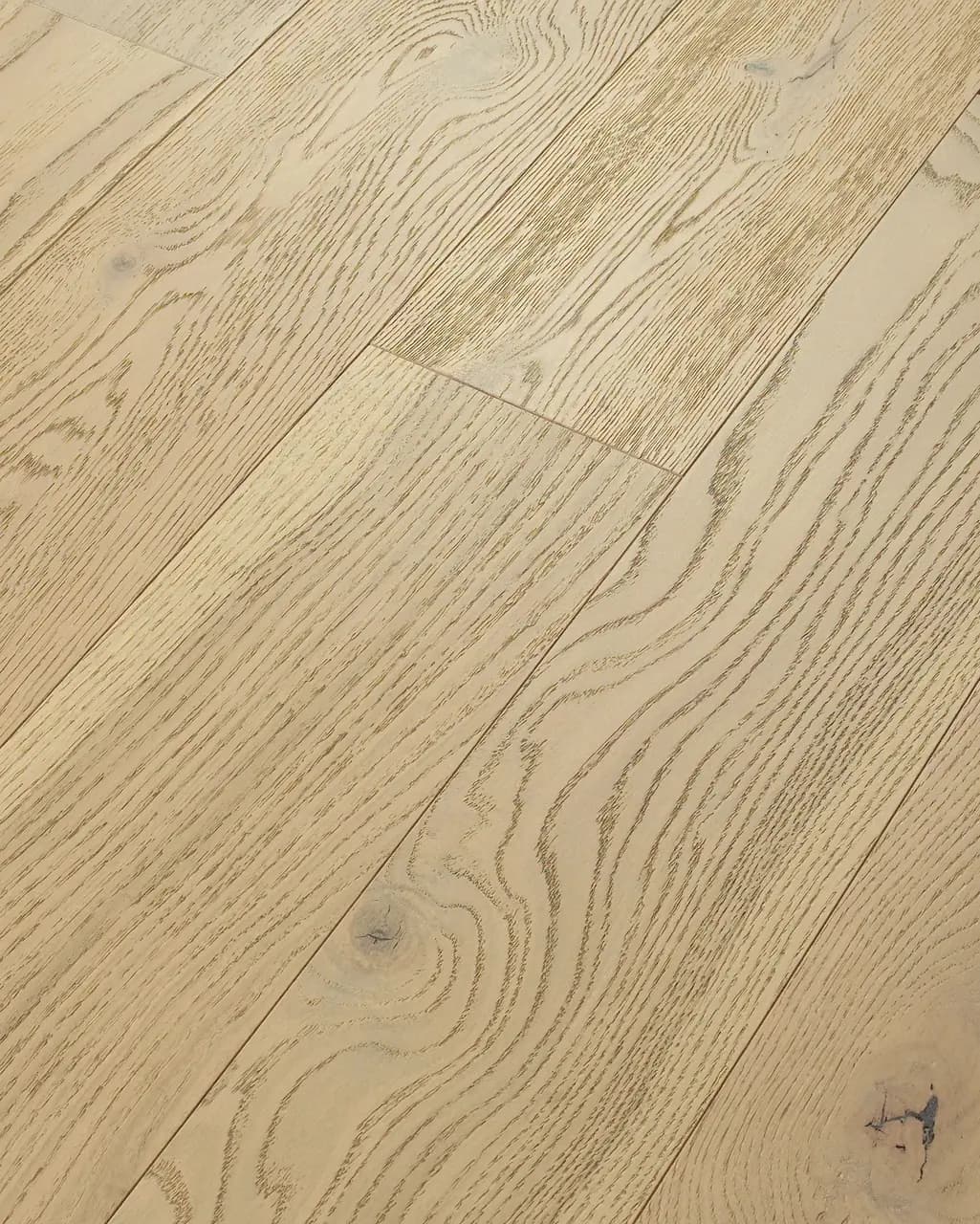 Close-up of wire-brushed white oak hardwood showing a knot and natural grain texture