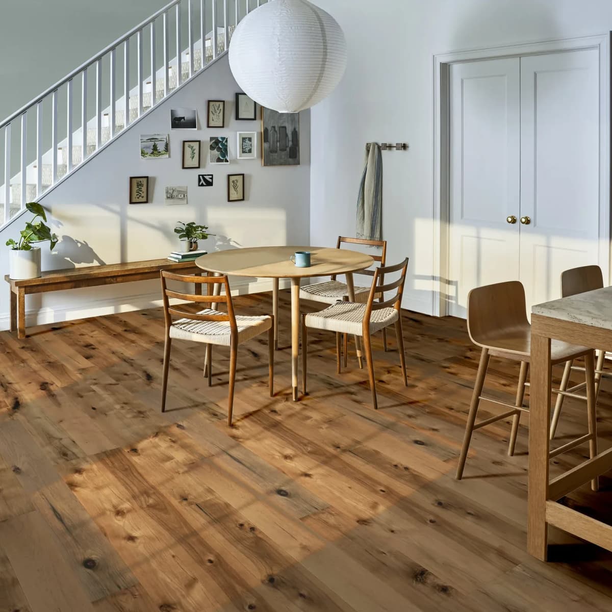Hickory hardwood floor with warm knots and color variation across a dining room