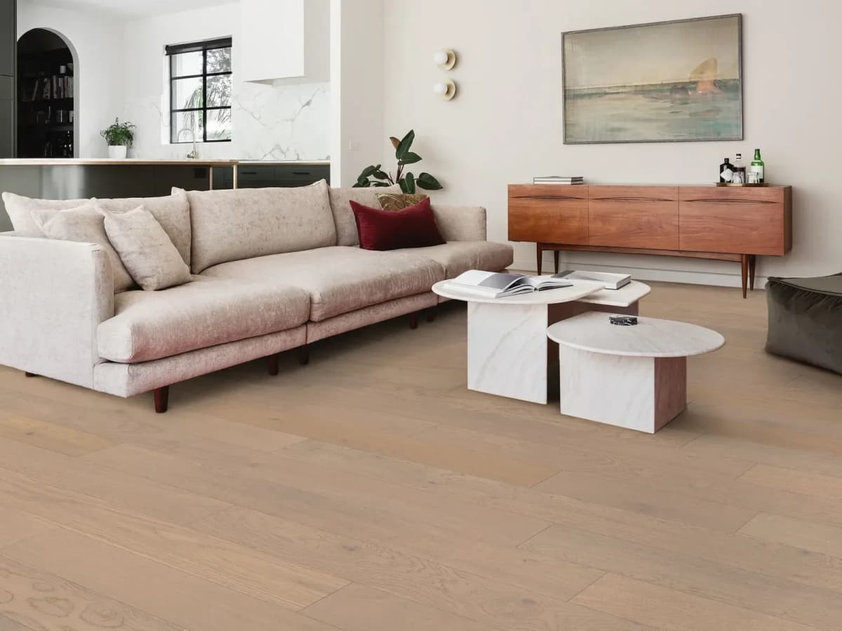 White oak hardwood flooring finishes a bright, newly renovated modern living room