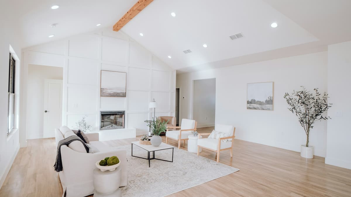 COREtec rigid-core luxury vinyl plank in a warm, sunlit living room, contrasting the softer WPC Originals look with the denser Pro construction