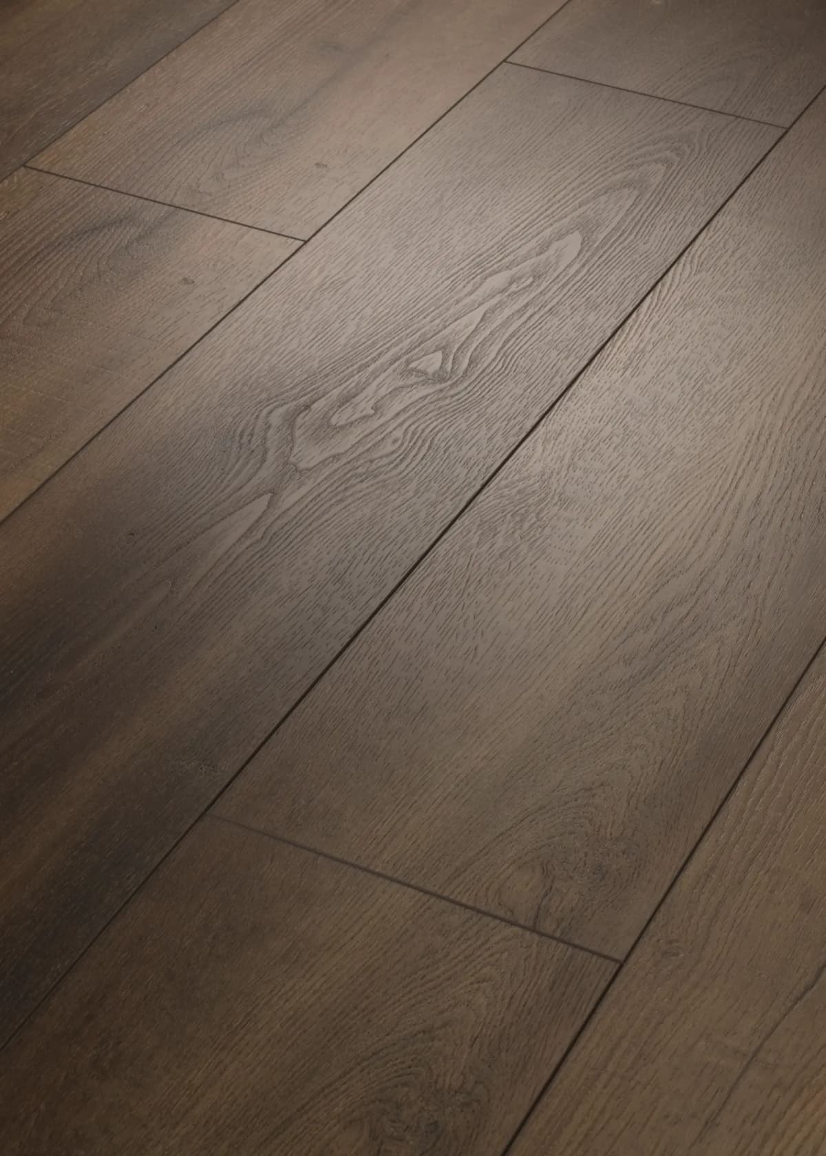 Close-up of warm brown COREtec Originals luxury vinyl plank showing printed wood grain and embossed texture