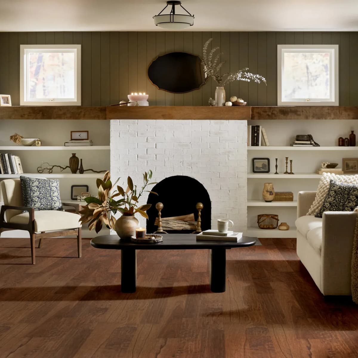Shaw Pebble Hill Hickory engineered hardwood in Warm Sunset in a living room with a fireplace and built-in shelving