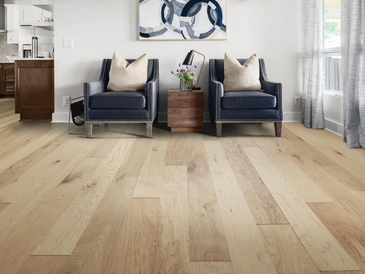 Linen hickory engineered hardwood flooring in a living room with two navy blue armchairs