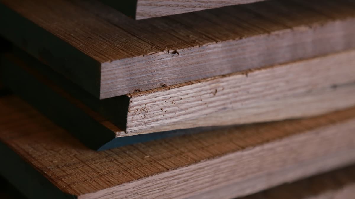 Cross-section of engineered hardwood plank showing wear layer above plywood core
