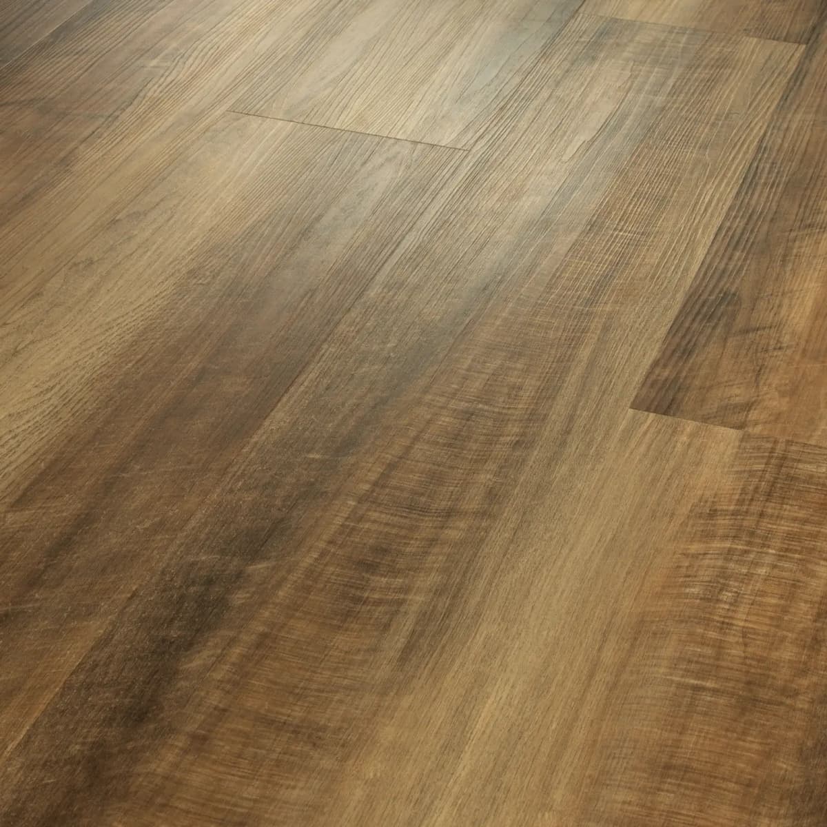 Close-up of warm tan and brown wood-look LVP planks showing printed grain and board-to-board color variation