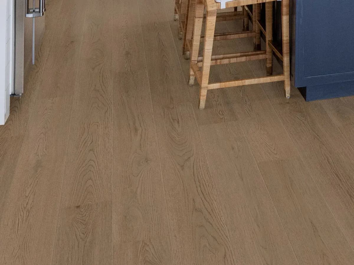 Shaw Coffeehouse luxury vinyl plank flooring runs through a bright kitchen with bar seating