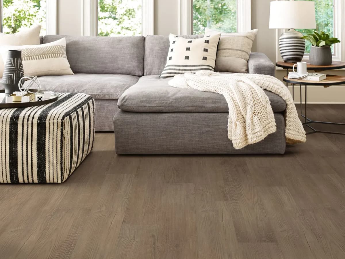 Casual Comfort luxury vinyl plank flooring in a bright living room with a sectional sofa