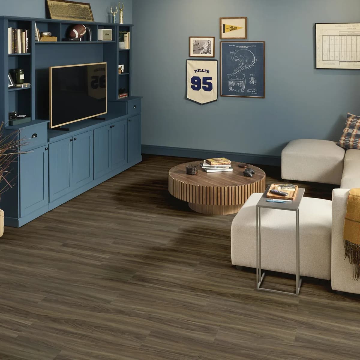 Cinnamon Walnut Shaw luxury vinyl plank flooring grounding a modern living room with cream seating