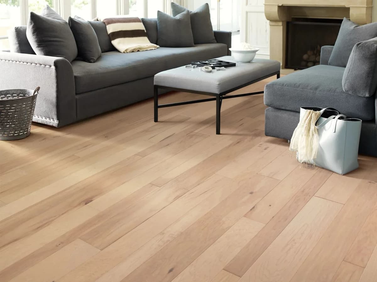 Shaw Pebble Hill hickory flooring in Linen laid tight and flat across a bright living room