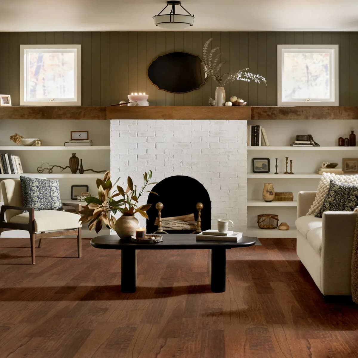 Warm Sunset hickory hardwood flooring grounds a cozy living room with a fireplace and built-ins