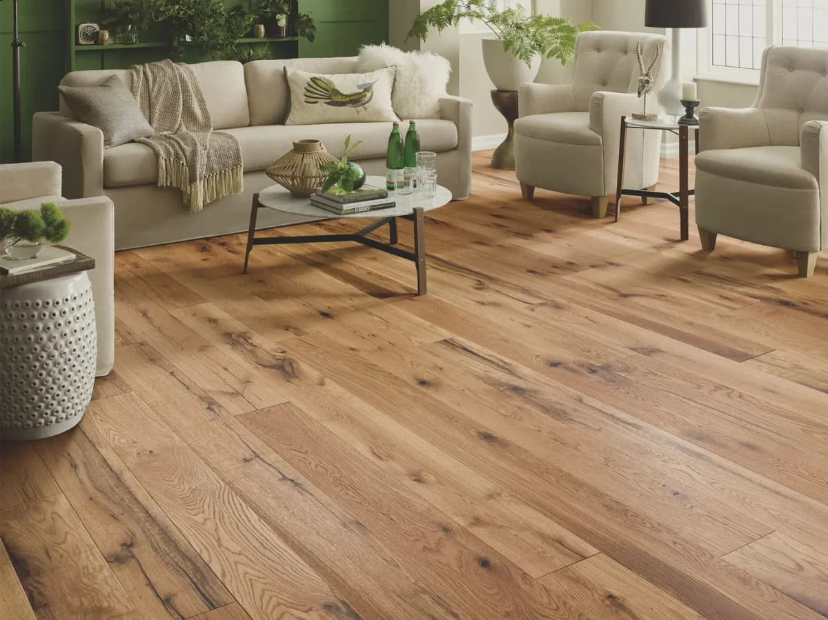 Natural white oak engineered hardwood flooring in a bright living room with cream seating and a marble coffee table