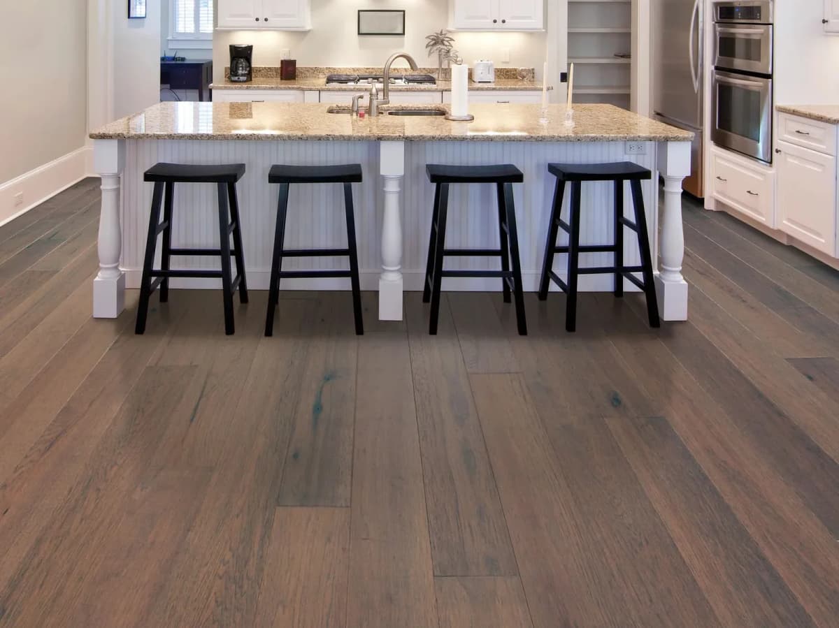 Tranquility hickory engineered hardwood flooring in a kitchen with a large island and bar stools