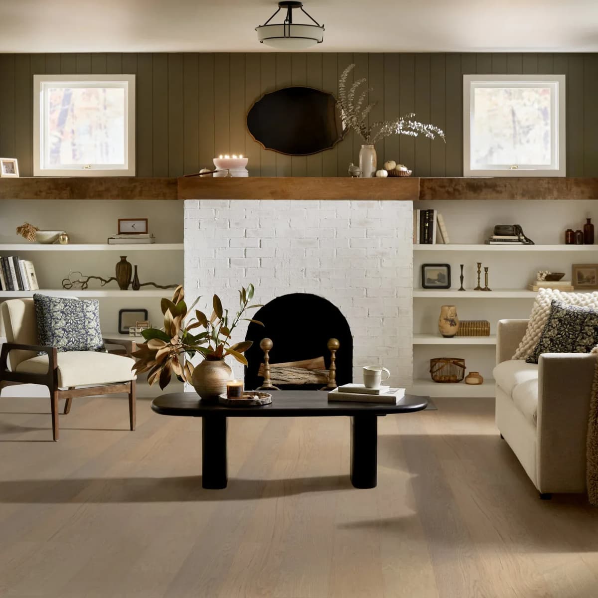 Haven oak engineered hardwood flooring filling a warm, sunlit living room with a fireplace