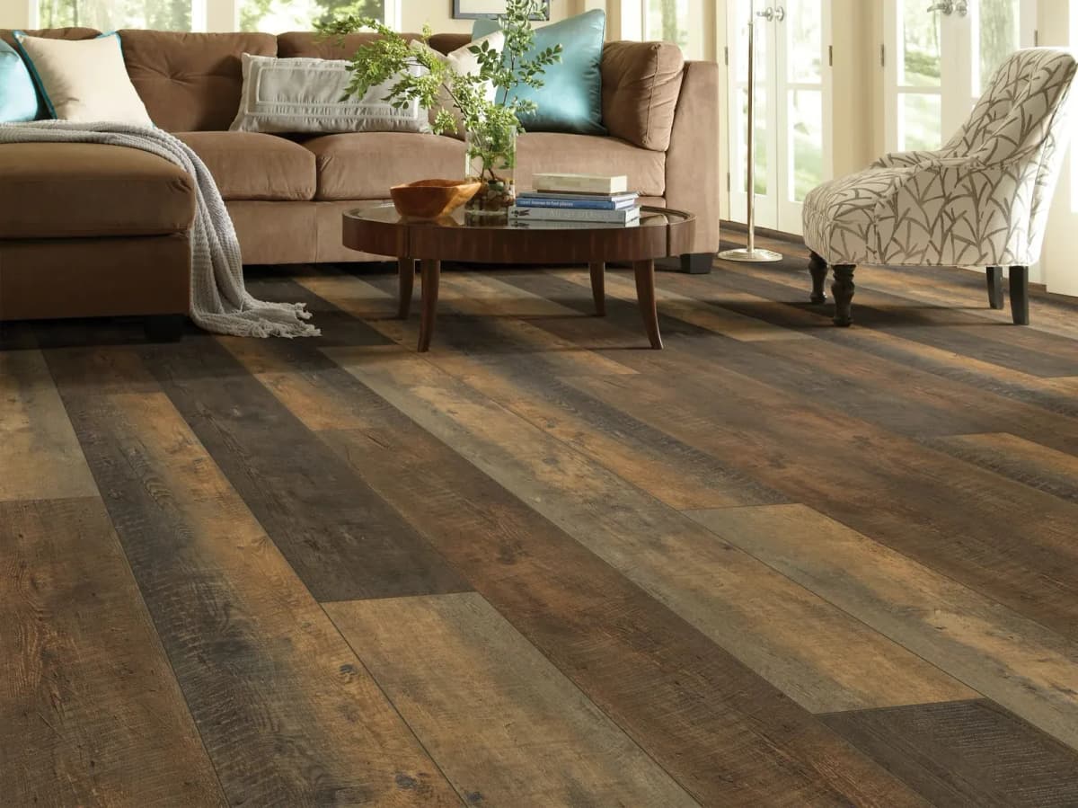 Autumn Barnboard luxury vinyl plank flooring with rustic multi-tone grain in a sunlit living room