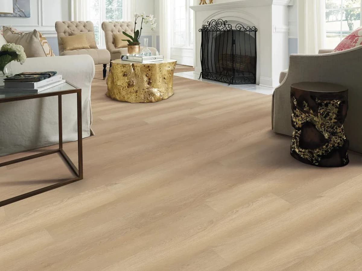 White Sand luxury vinyl plank flooring laid in neat, linear rows across a sunlit living room