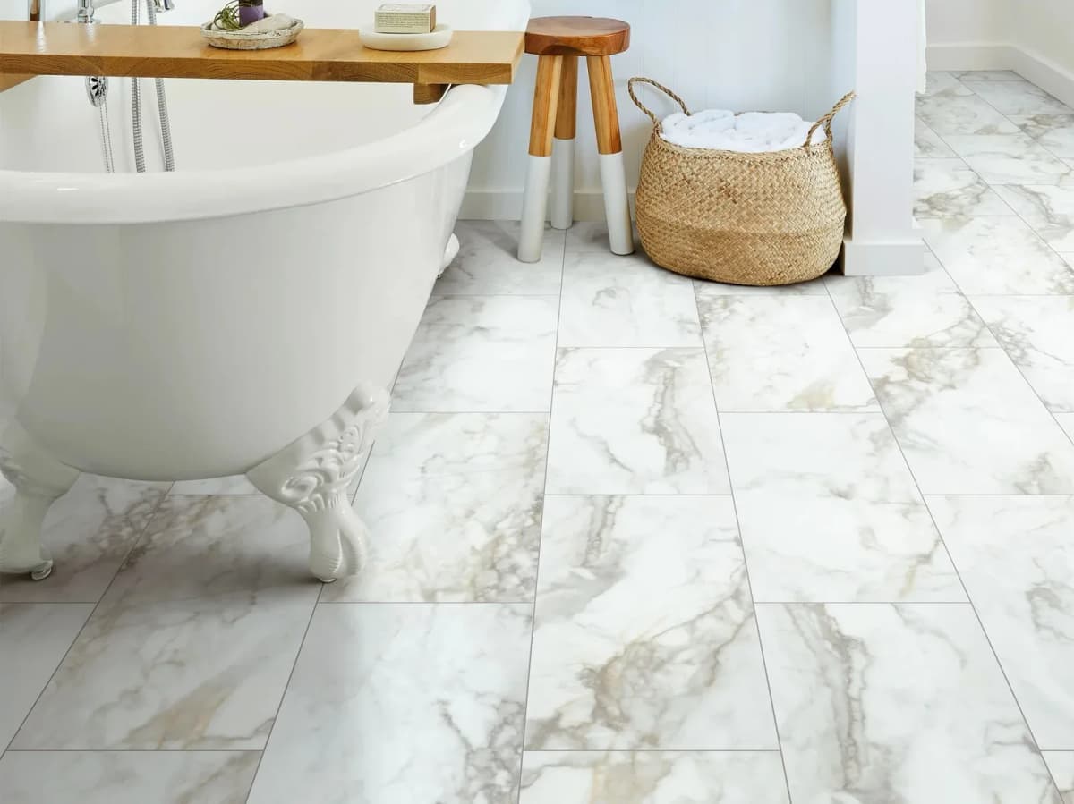 Large marble-look vinyl tile flooring in a bathroom with a freestanding tub