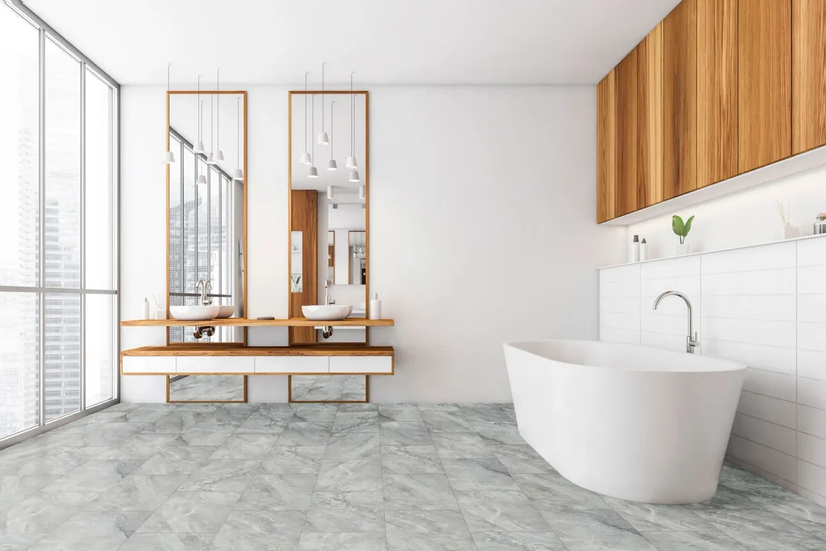 COREtec luxury vinyl tile in a cool gray marble look covers a modern bathroom.