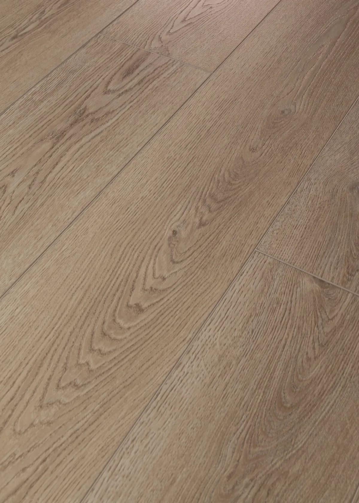 Close angled view of medium taupe vinyl planks showing wood grain and beveled seams.