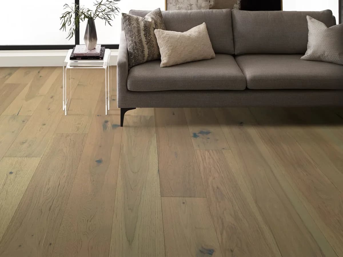 Pecan engineered hardwood plank flooring shows warm grain variation in a living room.