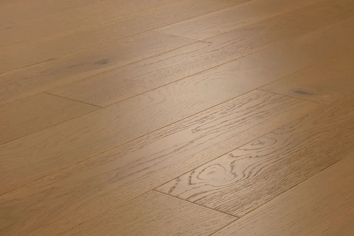 Light white oak plank flooring displays natural grain, knots, and subtle color variation.