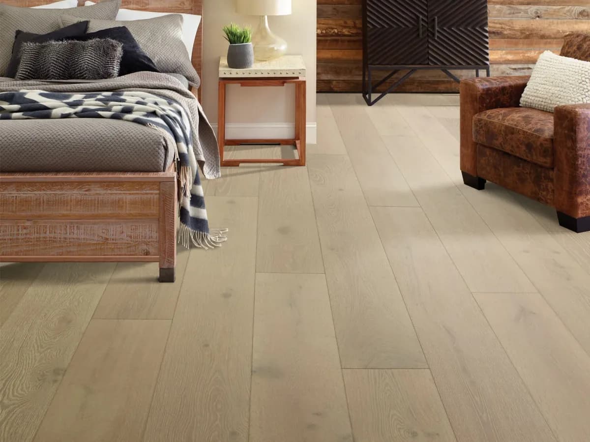 Anderson Tuftex wide-plank white oak flooring in a pale greige tone fills a bright bedroom.