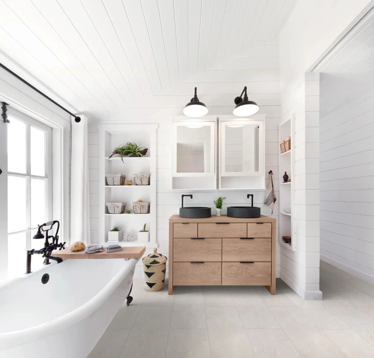 COREtec Pro Plus Enhanced Tile in Serena Limestone in a bright bathroom with a freestanding tub and a wood vanity