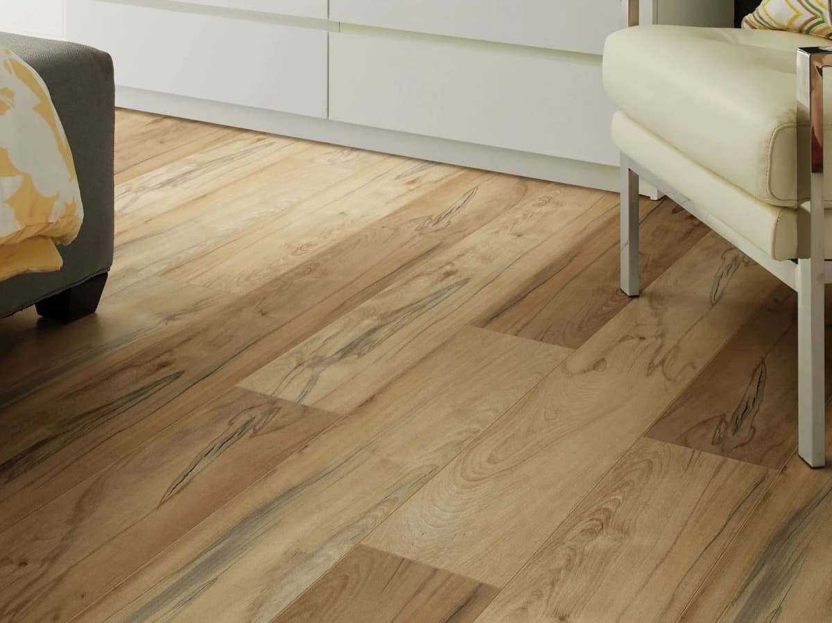 Shaw Titan HD Plus Platinum vinyl plank flooring in Imperial Beech laid diagonally in a bright room with modern furniture