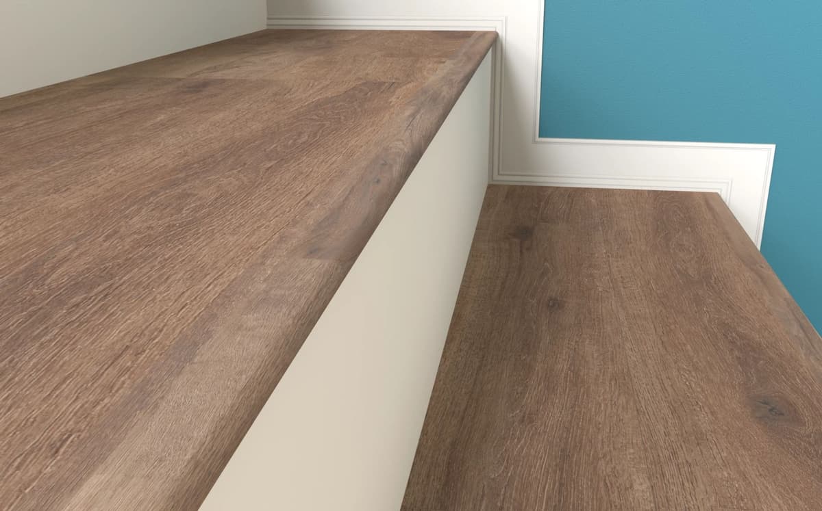 A stair nose wrapping the front edge of a single step down into a sunken room, in plank matching the floor